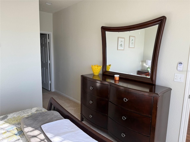 bedroom with carpet floors and baseboards