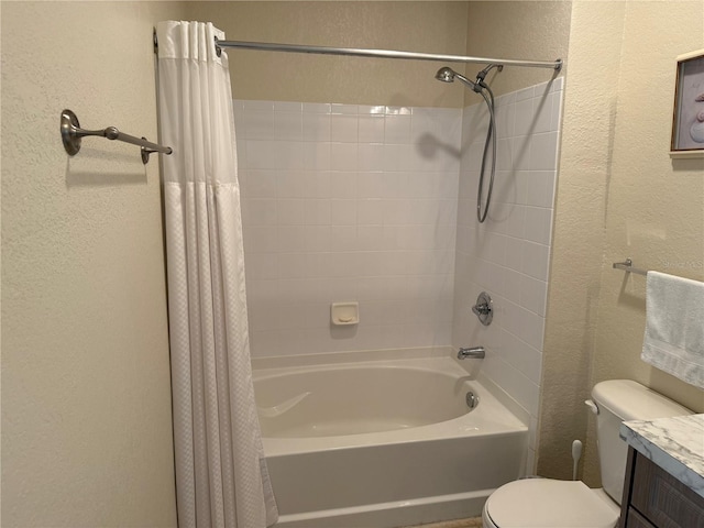 bathroom featuring a textured wall, vanity, shower / bath combination with curtain, and toilet