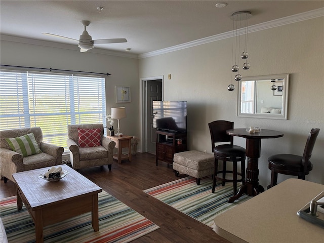 living area featuring crown molding, a ceiling fan, and wood finished floors