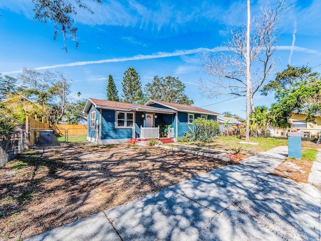 single story home with a fenced front yard and a porch