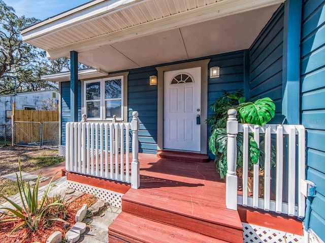 view of exterior entry featuring fence