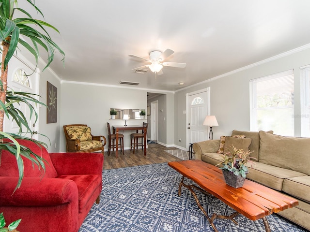 living room featuring ornamental molding, visible vents, ceiling fan, and dark wood-type flooring