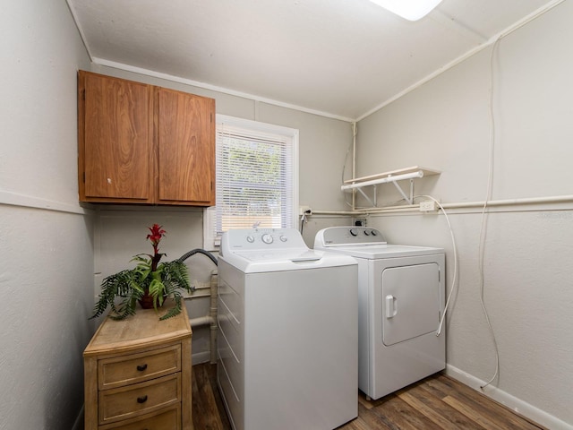 laundry room with cabinet space, baseboards, washer and clothes dryer, and dark wood-style flooring