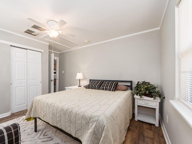 bedroom with crown molding, baseboards, and dark wood-style flooring