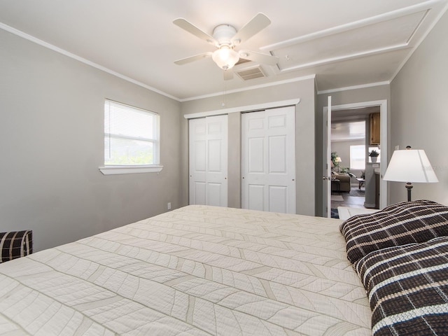 bedroom with ceiling fan, a closet, visible vents, and crown molding