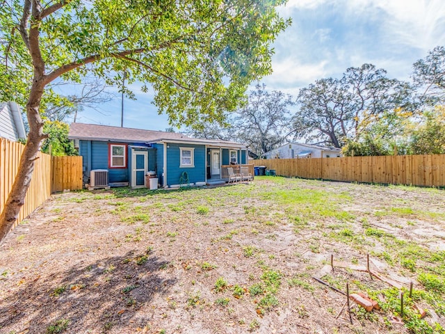 back of property featuring a fenced backyard and central air condition unit