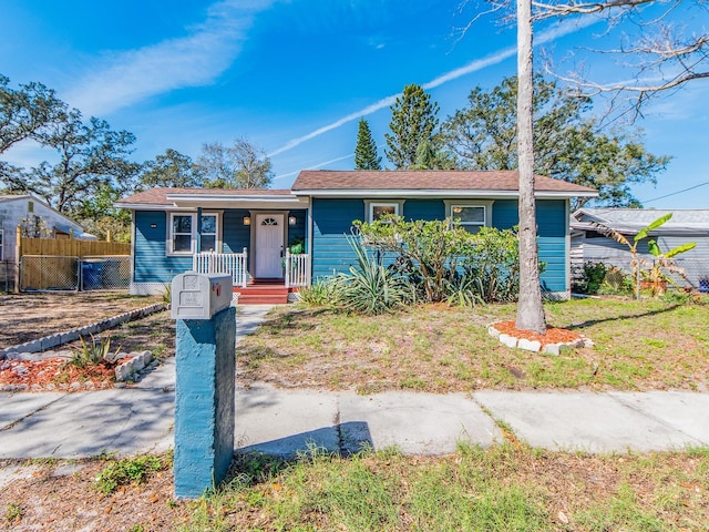 ranch-style house with fence and a front yard