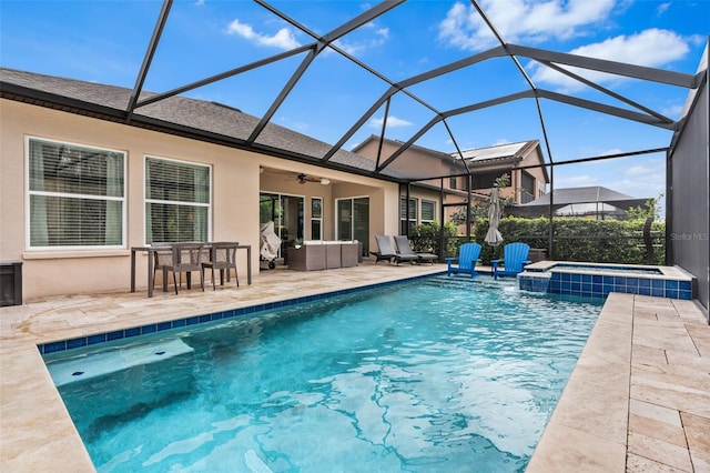 view of swimming pool featuring a pool with connected hot tub, an outdoor hangout area, glass enclosure, a patio area, and ceiling fan