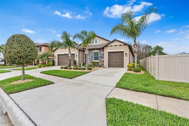 view of front facade featuring driveway, a garage, stone siding, fence, and stucco siding