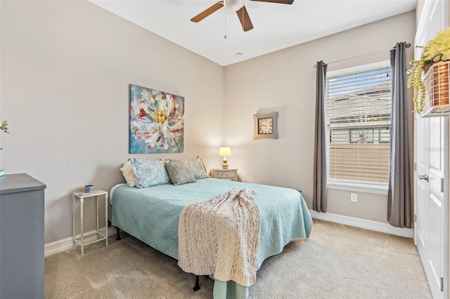 bedroom with light carpet, a ceiling fan, and baseboards