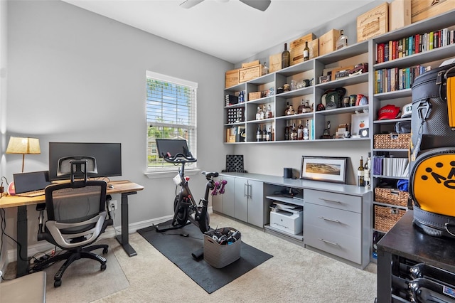 office with a ceiling fan, light colored carpet, and baseboards