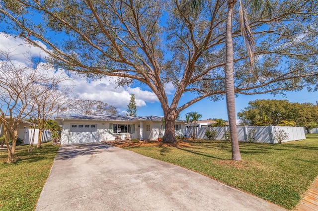 ranch-style house with concrete driveway, an attached garage, a front lawn, and fence