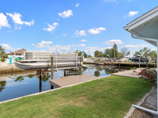 dock area featuring a yard, a water view, and boat lift