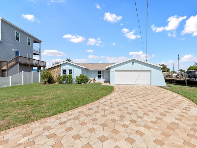 view of front of home featuring a balcony, an attached garage, fence, decorative driveway, and a front yard