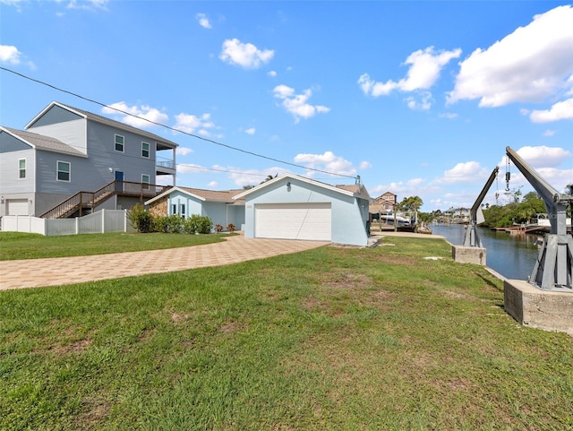 view of property exterior with a water view, a yard, driveway, and an attached garage