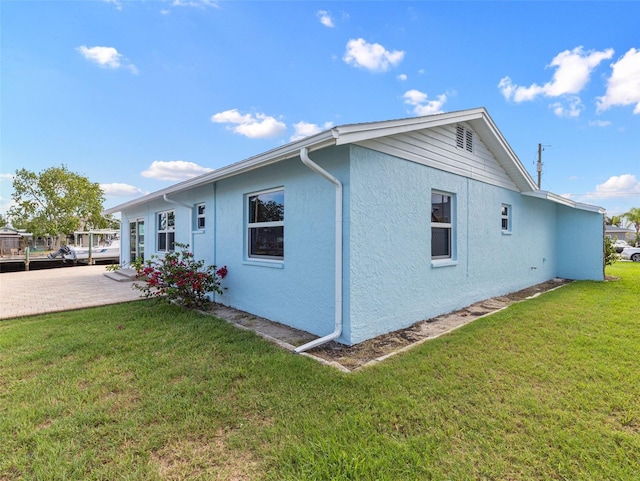 view of property exterior with a yard and stucco siding