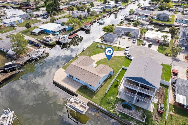 birds eye view of property featuring a water view and a residential view