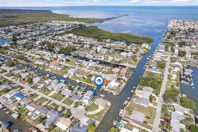 birds eye view of property with a water view and a residential view