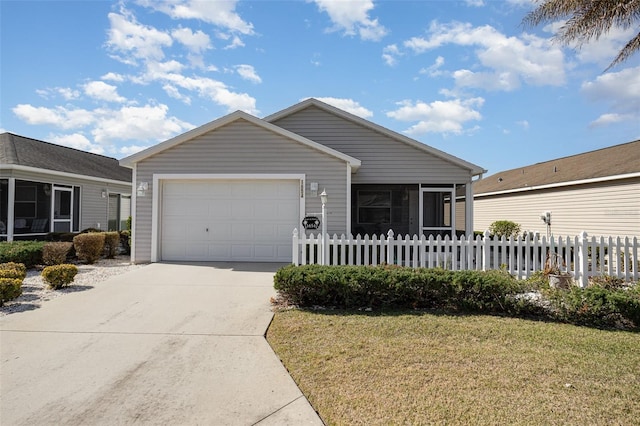 view of front of property with an attached garage, fence, a sunroom, driveway, and a front lawn