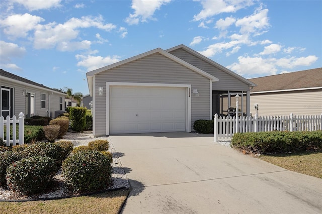 view of front of house featuring an attached garage, fence, and concrete driveway