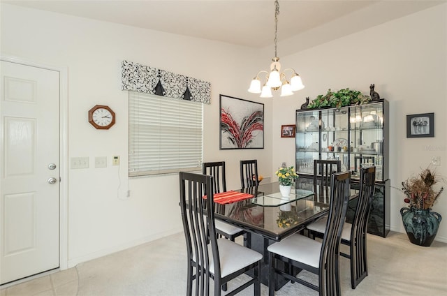 dining space featuring baseboards and an inviting chandelier