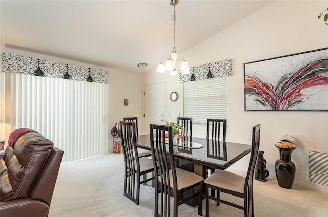 dining room featuring lofted ceiling, light carpet, a notable chandelier, and visible vents