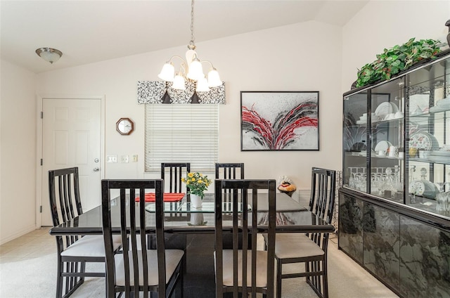 carpeted dining area with a chandelier and vaulted ceiling