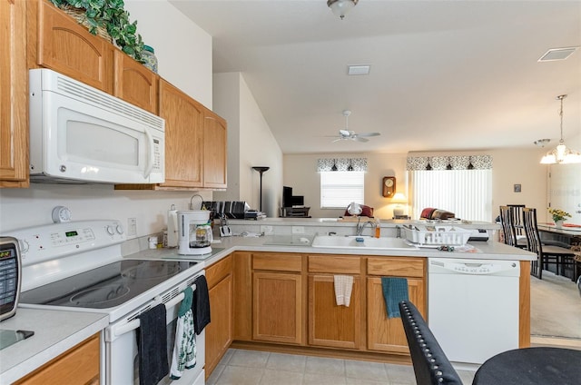 kitchen with a peninsula, white appliances, a sink, open floor plan, and light countertops