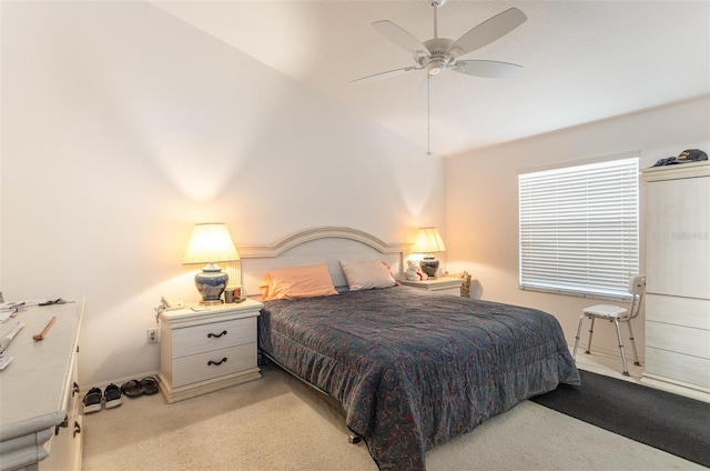 bedroom with lofted ceiling, baseboards, a ceiling fan, and light colored carpet