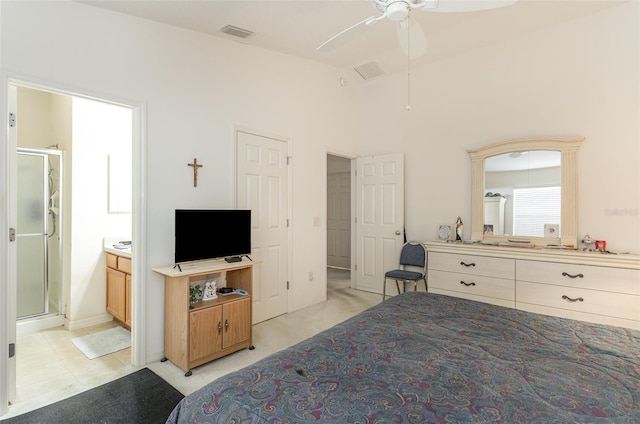 bedroom featuring visible vents, a ceiling fan, light colored carpet, ensuite bathroom, and high vaulted ceiling