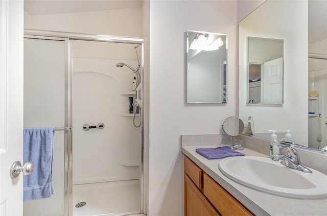 full bathroom with a stall shower and vanity