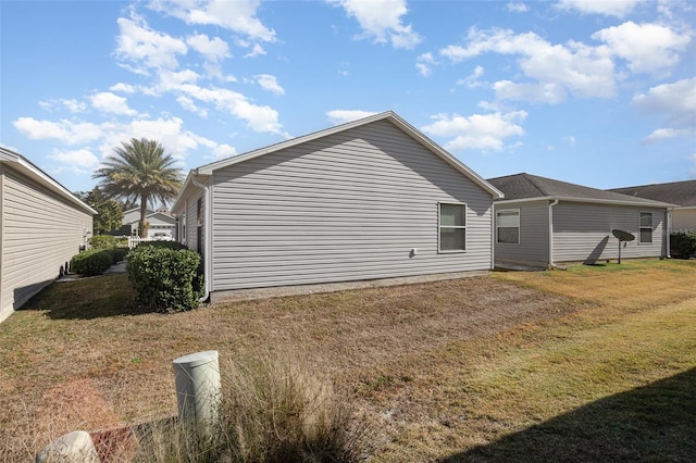 view of property exterior with a lawn