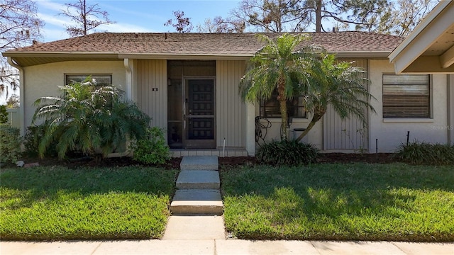 view of exterior entry featuring a yard