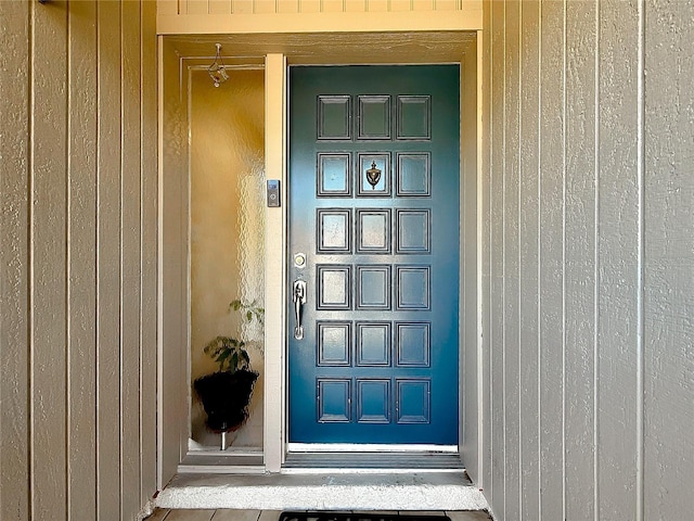 view of exterior entry featuring board and batten siding