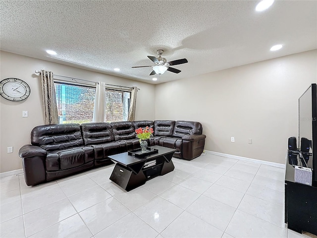 living room featuring recessed lighting, a textured ceiling, a ceiling fan, and light tile patterned flooring