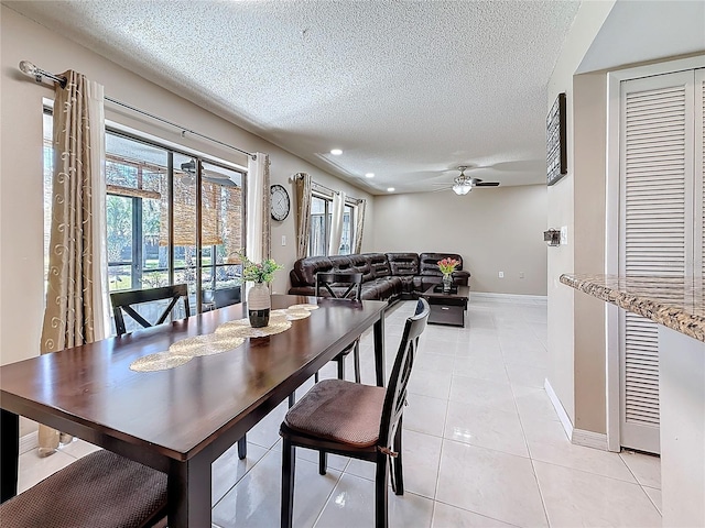 dining space with light tile patterned floors, ceiling fan, a textured ceiling, recessed lighting, and baseboards