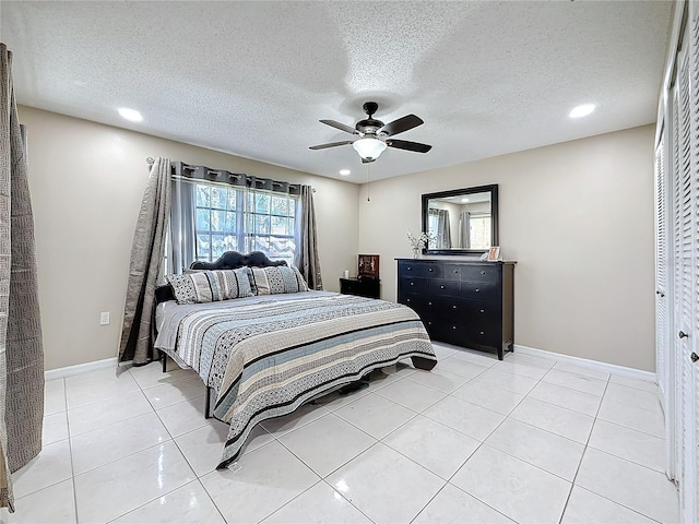 bedroom with light tile patterned floors, a textured ceiling, recessed lighting, a ceiling fan, and baseboards