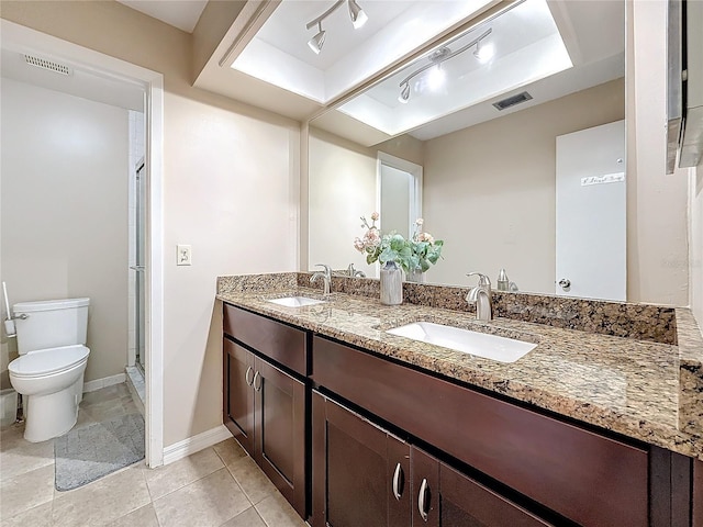 bathroom with visible vents, a sink, and double vanity