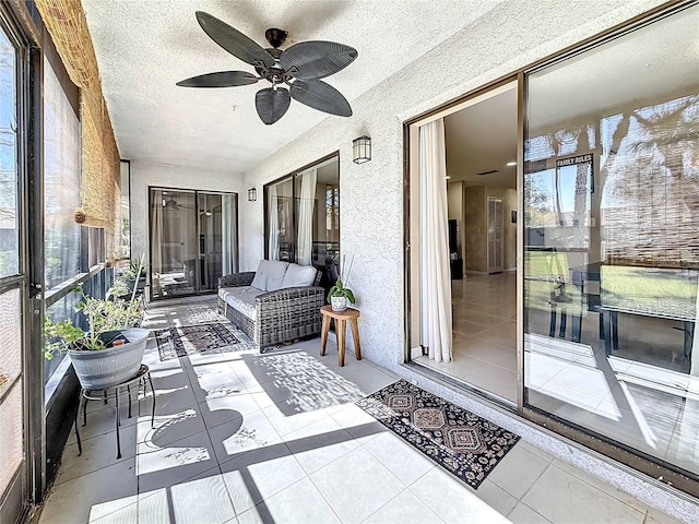 sunroom / solarium with a healthy amount of sunlight and a ceiling fan