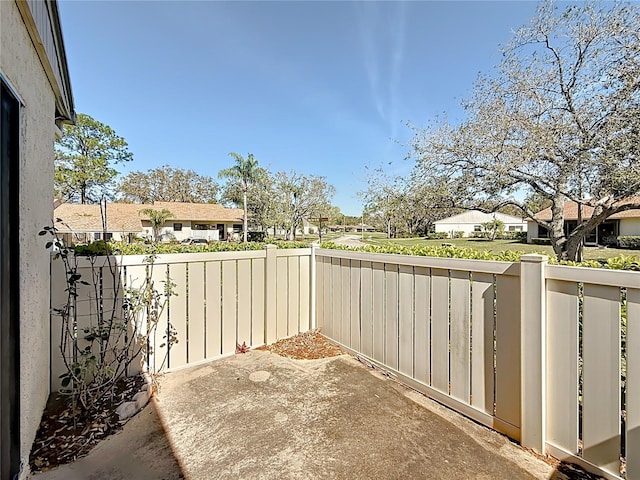 view of patio featuring a residential view and a fenced backyard