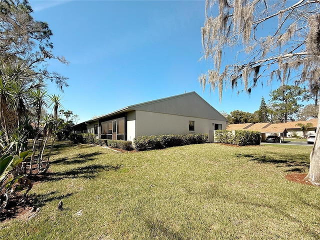 view of home's exterior with a lawn