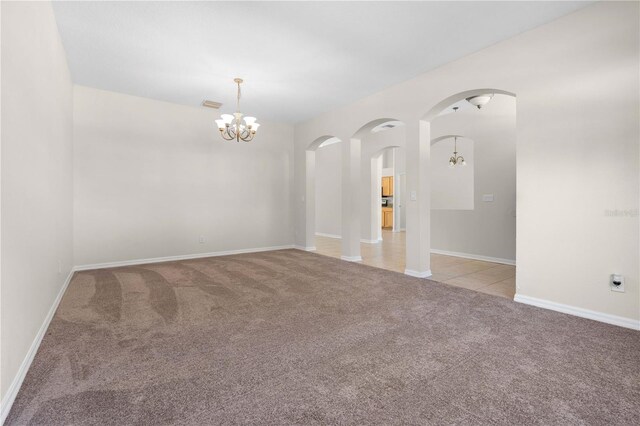 11611 Jordans Landing Ct, Riverview, FL 33569 - empty room featuring light colored carpet, a chandelier, and arched walkways