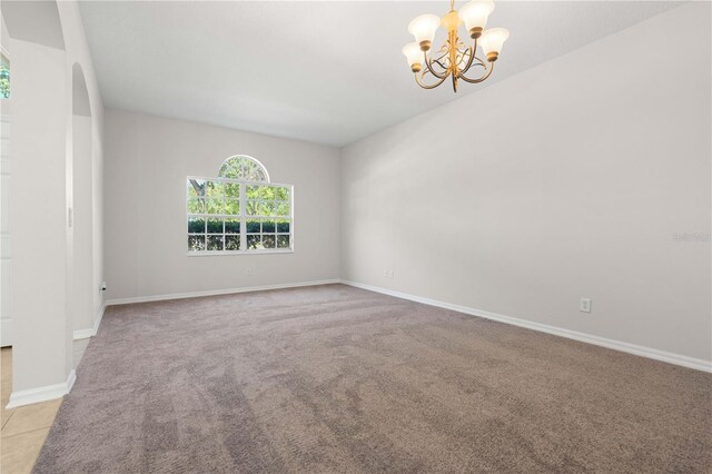 11611 Jordans Landing Ct, Riverview, FL 33569 - empty room with a chandelier, light colored carpet, arched walkways, and baseboards