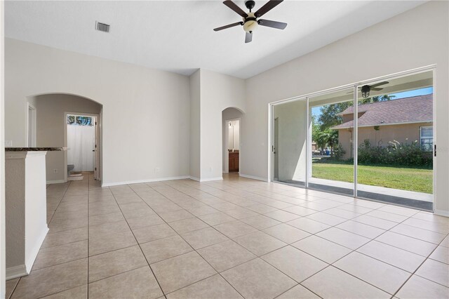 11611 Jordans Landing Ct, Riverview, FL 33569 - empty room featuring arched walkways, a ceiling fan, light tile patterned flooring, and baseboards