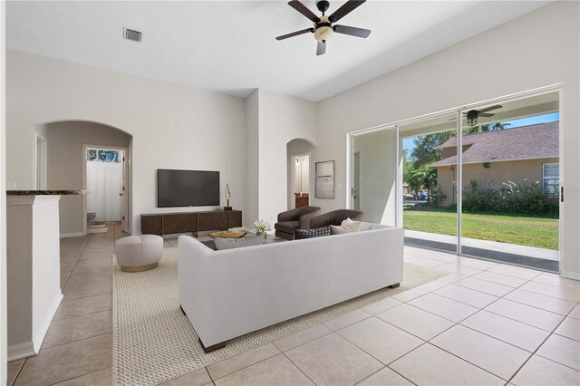 11611 Jordans Landing Ct, Riverview, FL 33569 - living room with arched walkways, a ceiling fan, and light tile patterned floors