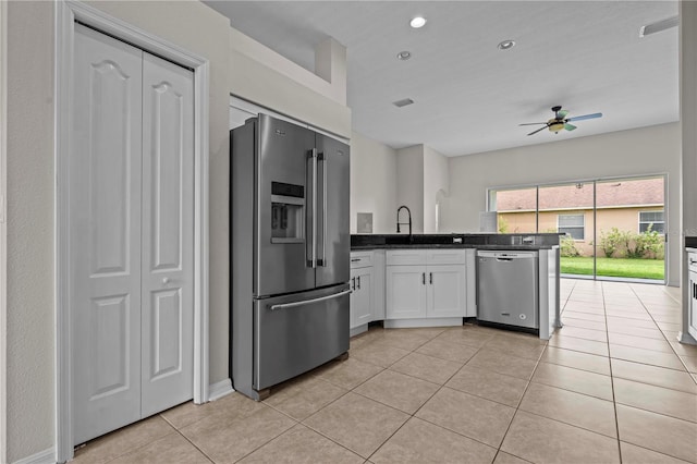 11611 Jordans Landing Ct, Riverview, FL 33569 - kitchen with stainless steel appliances, a ceiling fan, white cabinetry, light tile patterned flooring, and a peninsula