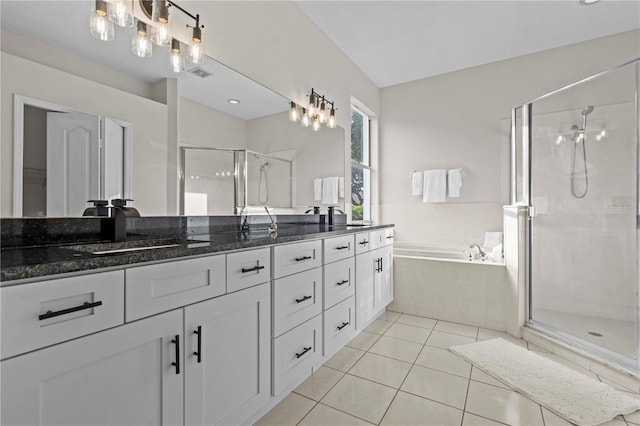 11611 Jordans Landing Ct, Riverview, FL 33569 - bathroom with double vanity, a shower stall, a bath, tile patterned floors, and a chandelier