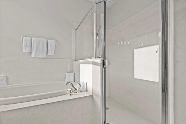 11611 Jordans Landing Ct, Riverview, FL 33569 - bathroom featuring a bath and a shower stall