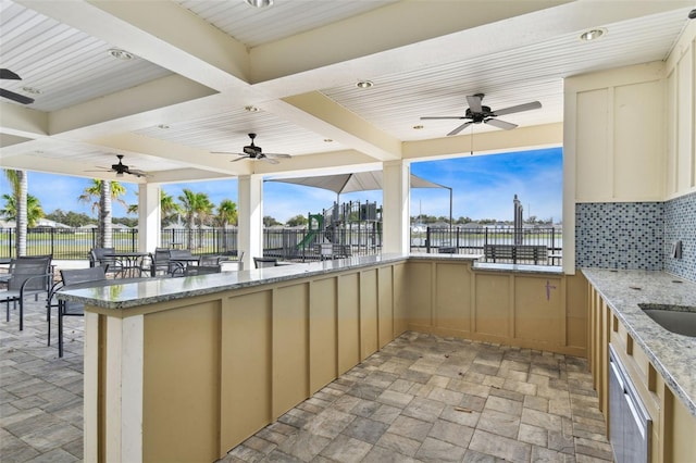 8034 Broad Pointe Dr, Zephyrhills, FL 33540 - view of patio / terrace with ceiling fan, exterior bar, and a water view