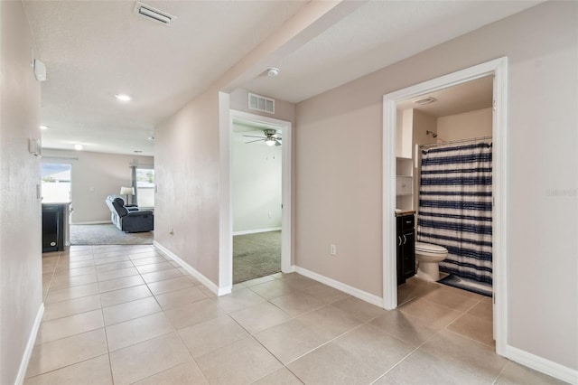 8034 Broad Pointe Dr, Zephyrhills, FL 33540 - hallway featuring light tile patterned floors and baseboards